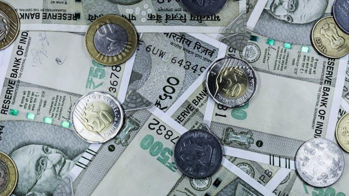 Rupee logs biggest weekly gain in more than a year, but underperforms peers